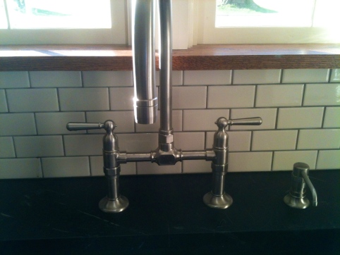 Subway tile, $120, American Olean in Biscuit, from off the shelf in Lowe's. Oak window sill, $25. Faucet, Priceless...